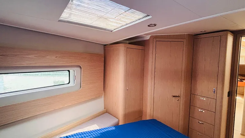  Yacht Photos Pics Luxurious interior cabin of 2024 Beneteau Oceanis Yacht 54 with wood finish.