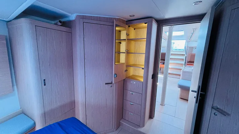  Yacht Photos Pics Luxurious interior of 2024 Beneteau Oceanis Yacht 54 with wooden cabinetry and modern design.