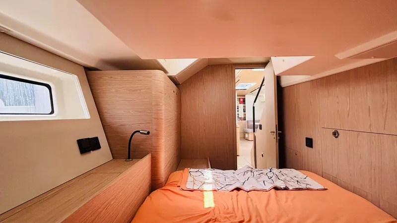  Yacht Photos Pics Luxurious cabin interior of 2024 Beneteau Oceanis Yacht 54 with modern wood finish.