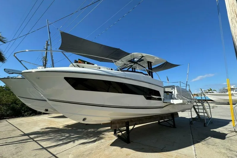  Yacht Photos Pics 2025 Jeanneau Leader 9.0 WA Series 2 boat on display under clear blue sky.