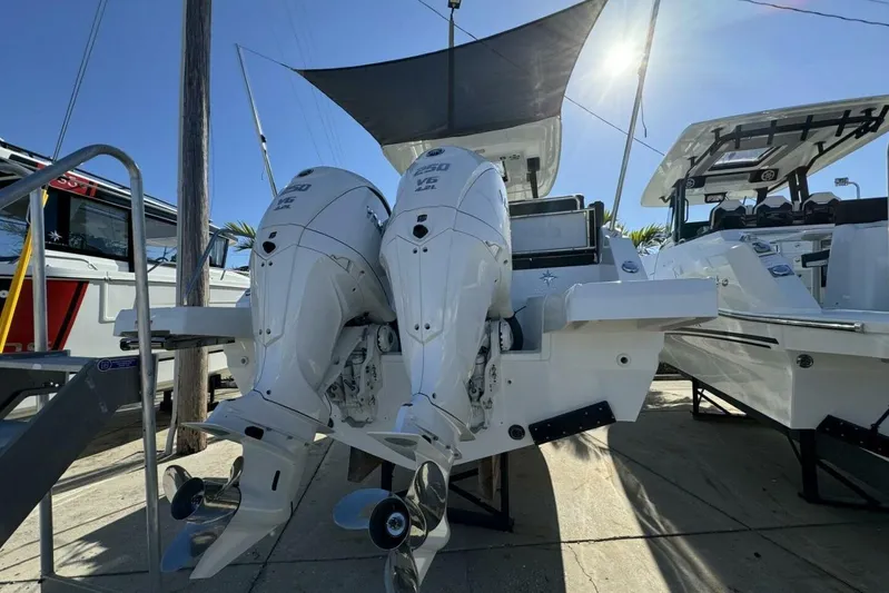  Yacht Photos Pics 2025 Jeanneau Leader 9.0 WA Series 2 with dual outboard engines, docked under sunlight.