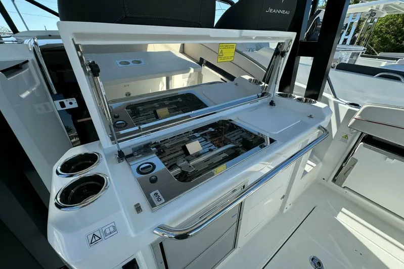  Yacht Photos Pics 2025 Jeanneau Leader 9.0 WA Series 2 boat interior with open grill and cup holders.