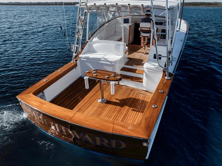  Yacht Photos Pics 1996 Garlington 44 Express yacht with wooden deck, cruising on calm blue waters.