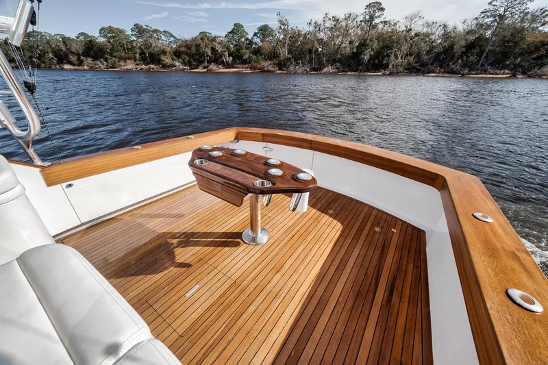  Yacht Photos Pics 1996 Garlington 44 Express boat with wooden deck, scenic river view.