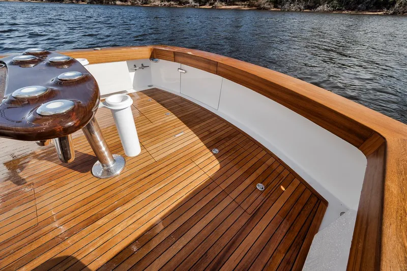  Yacht Photos Pics Garlington 44 Express 1996 boat deck with wooden flooring and fishing rod holders.