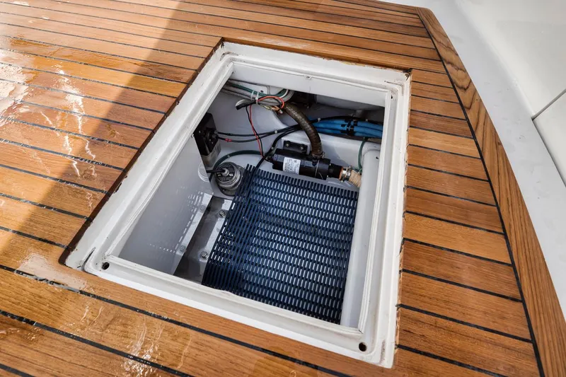  Yacht Photos Pics Open hatch on 1996 Garlington 44 Express boat deck, revealing internal components.