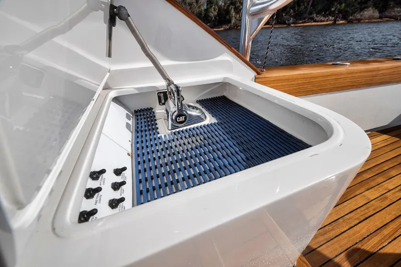  Yacht Photos Pics Garlington 44 Express 1996 boat sink with faucet and blue mat on wooden deck.
