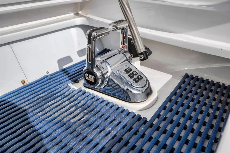  Yacht Photos Pics Garlington 44 Express 1996 boat throttle control with CAT branding and blue mat.