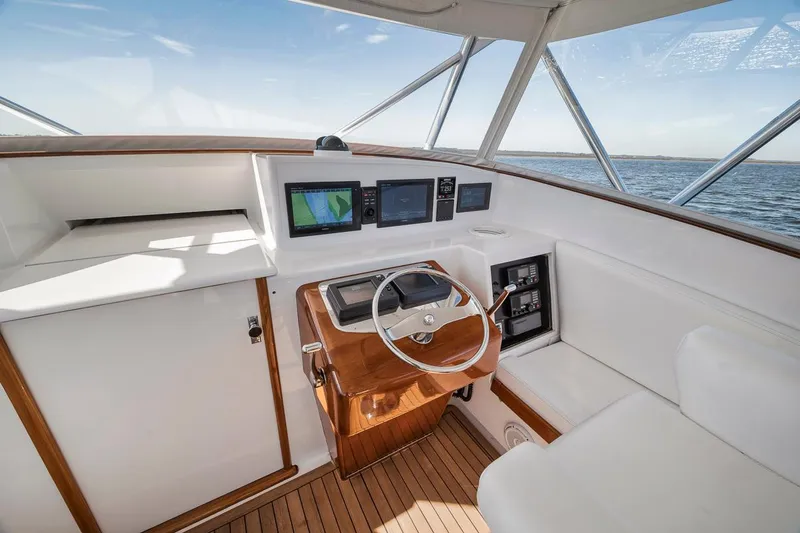  Yacht Photos Pics 1996 Garlington 44 Express boat helm with modern navigation equipment and wooden accents.