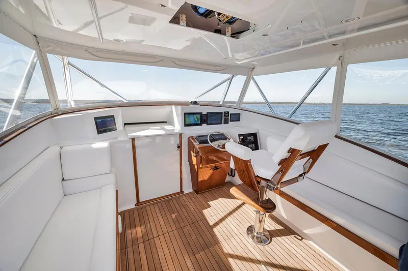  Yacht Photos Pics Interior of 1996 Garlington 44 Express yacht with wooden flooring and white seating.