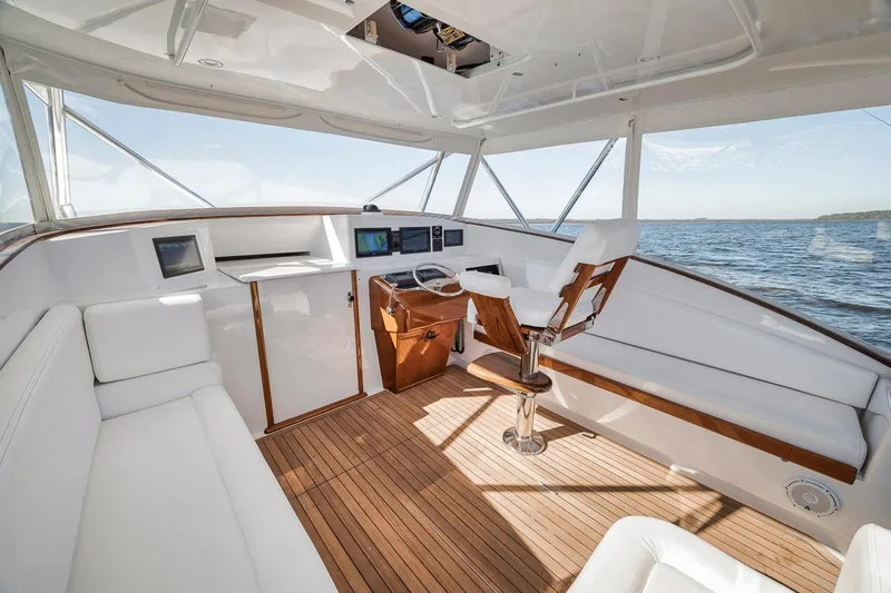  Yacht Photos Pics Luxurious interior of 1996 Garlington 44 Express yacht with wooden flooring and modern controls.