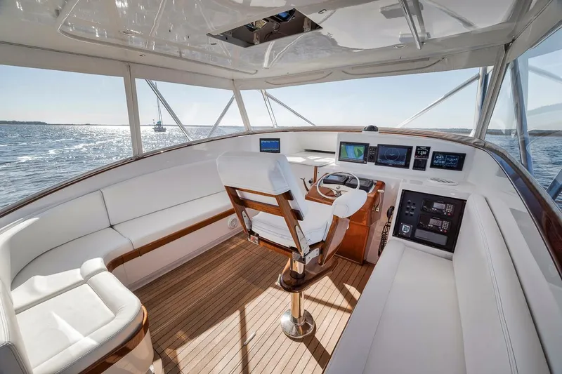  Yacht Photos Pics Interior of 1996 Garlington 44 Express yacht with white seating and wooden flooring.