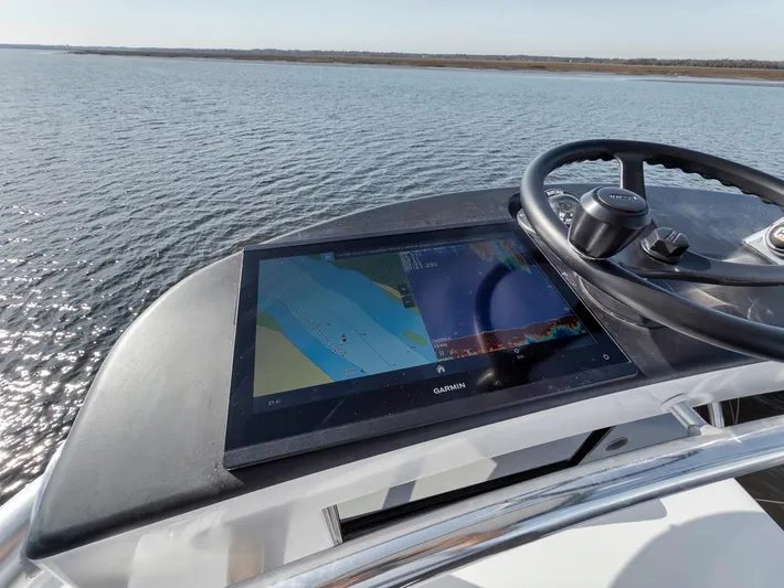  Yacht Photos Pics Garlington 44 Express 1996 helm with navigation display on calm water.