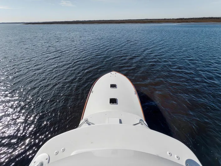  Yacht Photos Pics Garlington 44 Express 1996 boat cruising on open water, view from the bow.