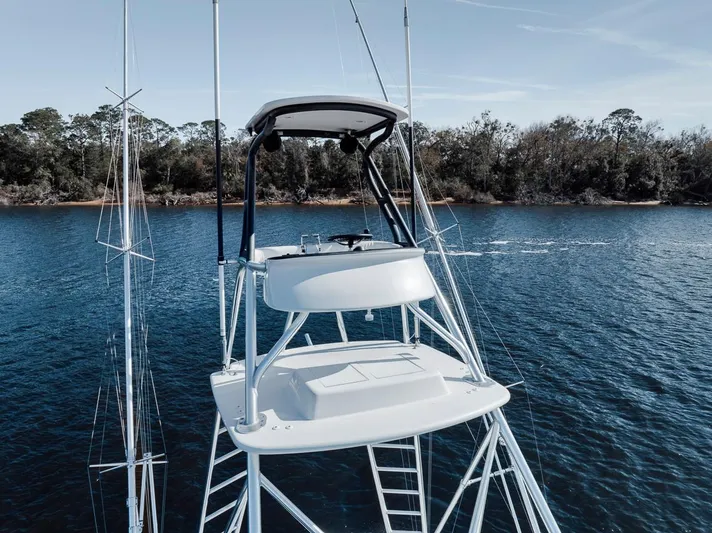  Yacht Photos Pics 1996 Garlington 44 Express yacht on calm water with lush shoreline.