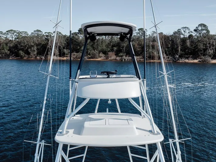  Yacht Photos Pics 1996 Garlington 44 Express boat on calm water with forested shoreline in background.