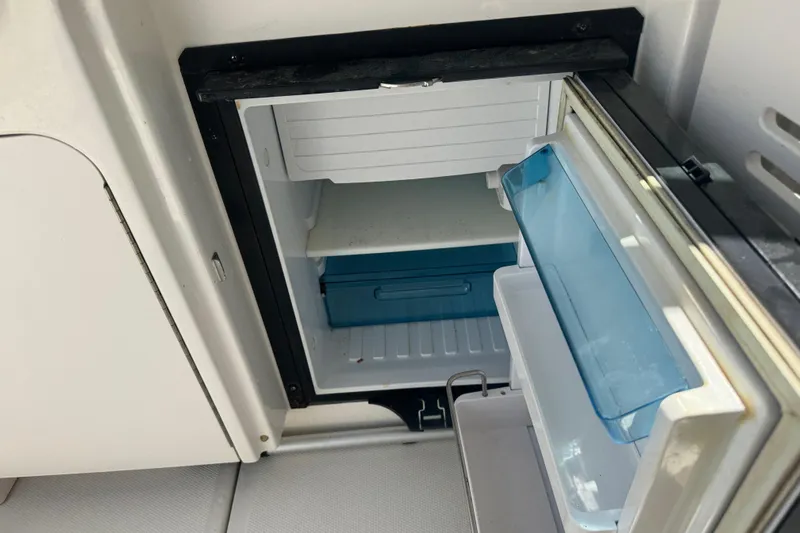  Yacht Photos Pics Open refrigerator on 2010 Sea Ray 390 Sundancer boat, showing interior shelves and compartments.
