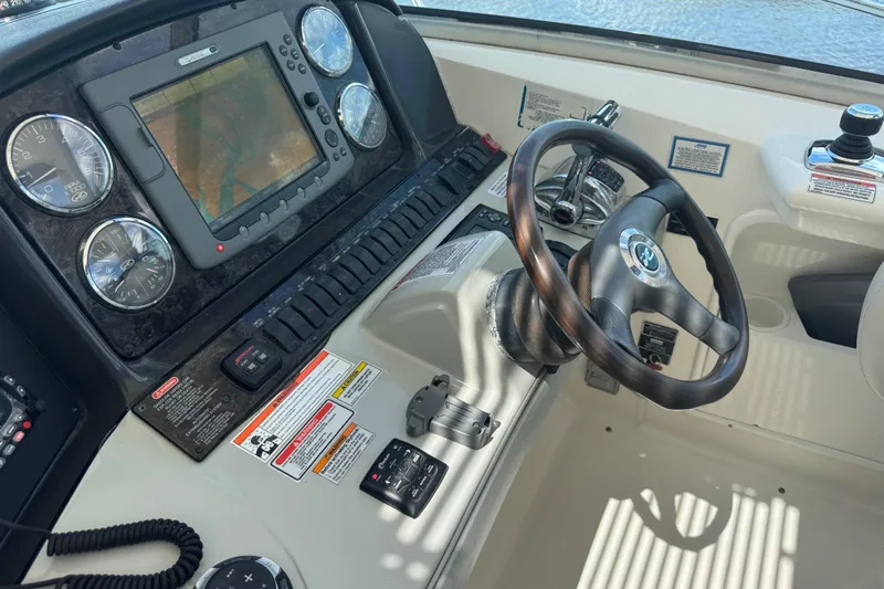  Yacht Photos Pics Dashboard of 2010 Sea Ray 390 Sundancer with steering wheel and navigation controls.