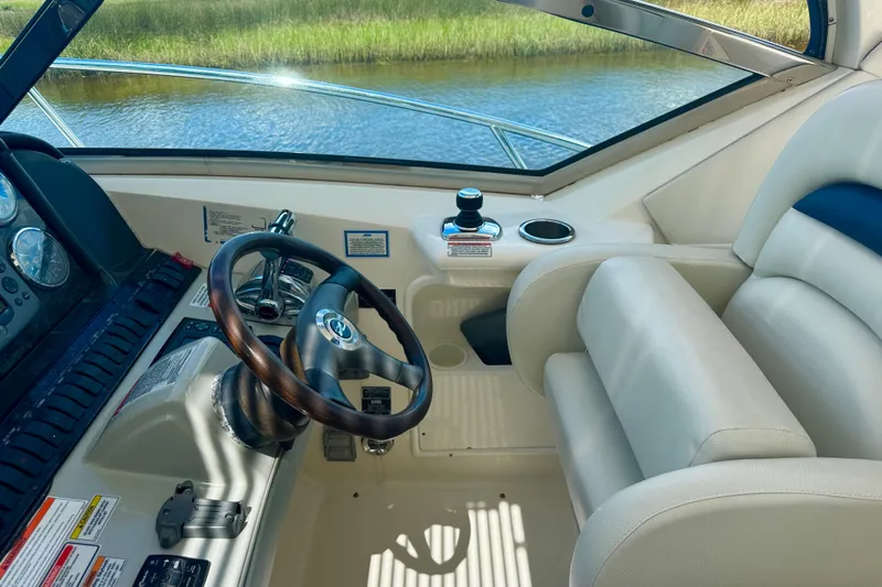  Yacht Photos Pics Helm of 2010 Sea Ray 390 Sundancer with leather seating and wooden steering wheel.