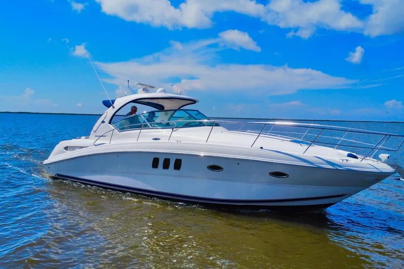 Yacht Photos Pics 2010 Sea Ray 390 Sundancer cruising on open water under a clear blue sky.