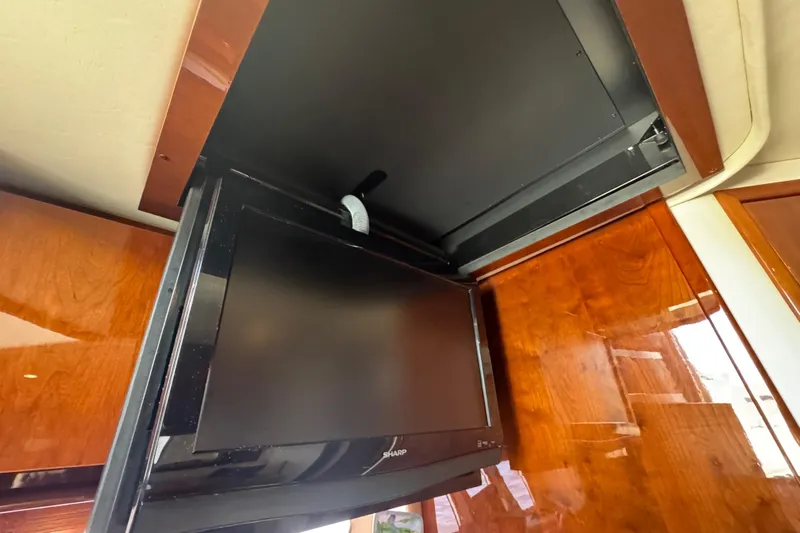 Yacht Photos Pics Flat-screen TV in 2010 Sea Ray 390 Sundancer yacht interior, mounted on wooden paneling.