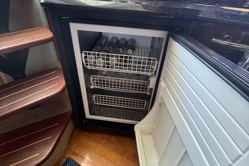  Yacht Photos Pics Open fridge with beverages inside a 2010 Sea Ray 390 Sundancer yacht interior.