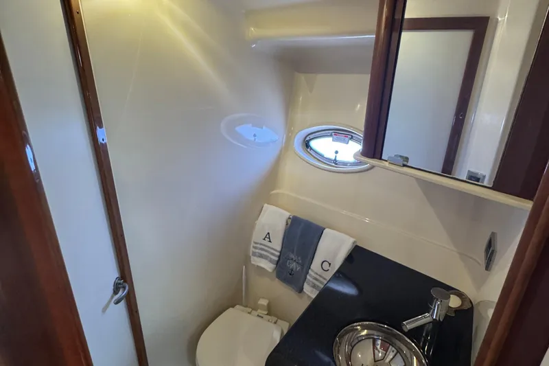  Yacht Photos Pics Bathroom interior of 2010 Sea Ray 390 Sundancer yacht with sink and porthole.