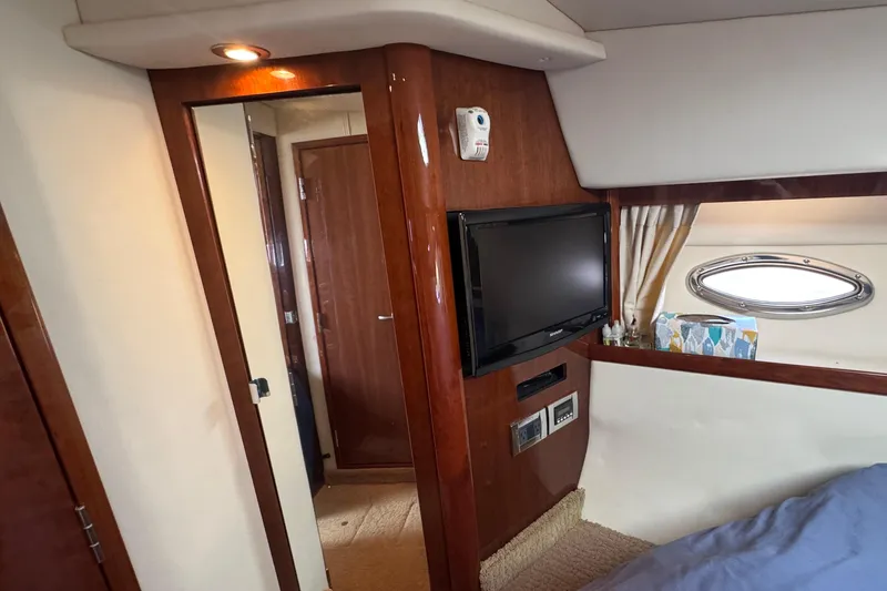  Yacht Photos Pics Interior of 2010 Sea Ray 390 Sundancer with TV, porthole, and wooden finishes.