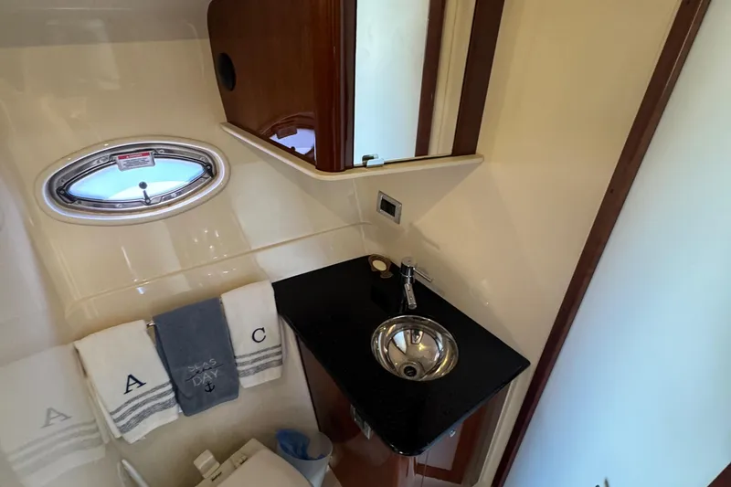  Yacht Photos Pics Luxurious bathroom in 2010 Sea Ray 390 Sundancer yacht with sleek sink and porthole window.