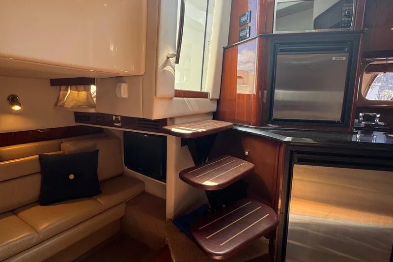  Yacht Photos Pics Interior of 2010 Sea Ray 390 Sundancer yacht with seating, stairs, and kitchenette.