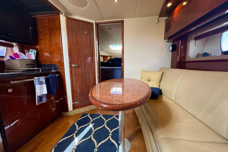 Yacht Photos Pics Luxurious interior of 2010 Sea Ray 390 Sundancer yacht with elegant seating and wooden finishes.