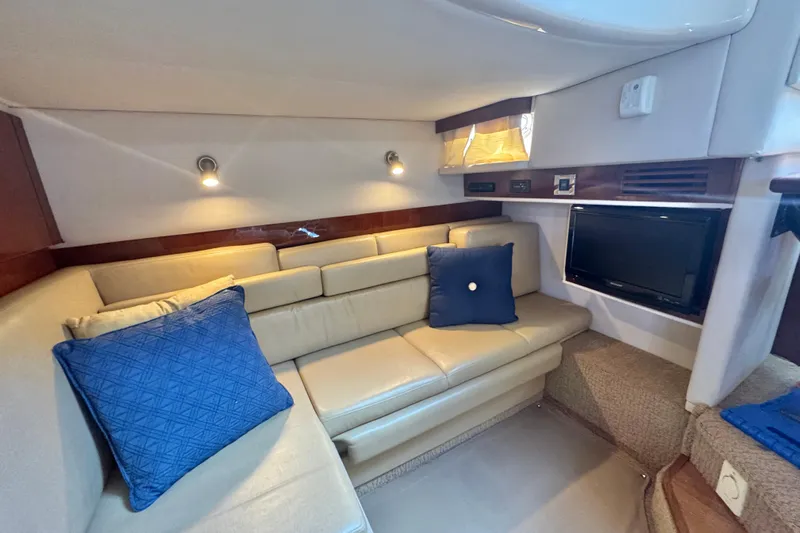  Yacht Photos Pics Luxurious interior of 2010 Sea Ray 390 Sundancer with beige seating and blue cushions.