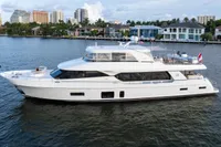 Luxury 2020 Ocean Alexander 100 MY yacht cruising near waterfront homes.