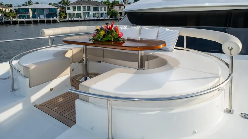 Iridescence Yacht Photos Pics Luxurious seating area on 2020 Ocean Alexander 100 MY yacht with elegant table and floral arrangement.