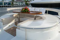 Luxurious seating area on 2020 Ocean Alexander 100 MY yacht with elegant table and floral arrangement.