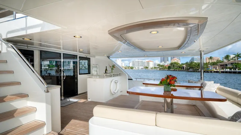 Iridescence Yacht Photos Pics Luxurious Ocean Alexander 100 MY yacht deck with elegant seating and waterfront view, 2020 model.