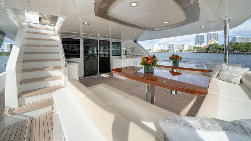 Iridescence Yacht Photos Pics Luxurious Ocean Alexander 100 MY yacht deck with elegant seating and scenic waterfront view.