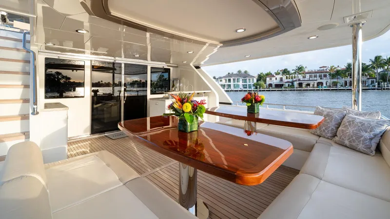 Iridescence Yacht Photos Pics Luxurious Ocean Alexander 100 MY yacht deck with elegant seating and waterfront view, 2020 model.