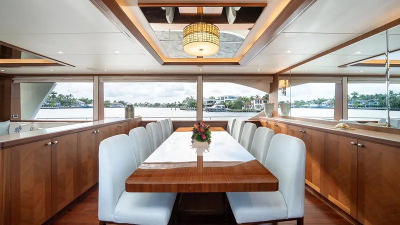 Iridescence Yacht Photos Pics Luxurious dining area on 2020 Ocean Alexander 100 MY yacht with elegant wood finishes.