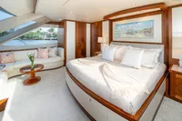 Luxurious bedroom interior on 2020 Ocean Alexander 100 MY yacht, featuring elegant decor and waterfront view.