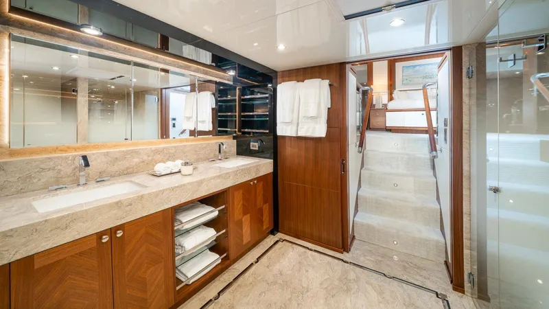 Iridescence Yacht Photos Pics Luxurious bathroom on 2020 Ocean Alexander 100 MY yacht with dual sinks and elegant wood cabinetry.
