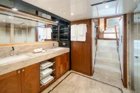 Luxurious bathroom on 2020 Ocean Alexander 100 MY yacht with dual sinks and elegant wood cabinetry.