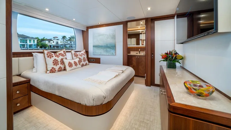 Iridescence Yacht Photos Pics Luxurious bedroom interior on 2020 Ocean Alexander 100 MY yacht, featuring elegant decor and large window.