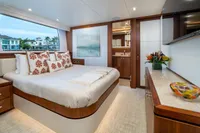 Luxurious bedroom interior on 2020 Ocean Alexander 100 MY yacht, featuring elegant decor and large window.