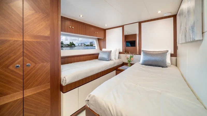Iridescence Yacht Photos Pics Luxurious twin bedroom on 2020 Ocean Alexander 100 MY yacht, featuring elegant wood finishes.