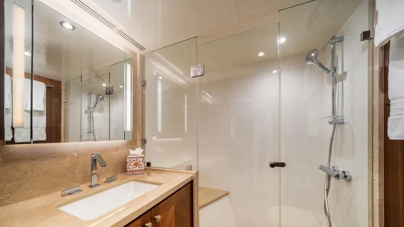 Iridescence Yacht Photos Pics Luxurious bathroom in 2020 Ocean Alexander 100 MY yacht with glass shower and modern fixtures.