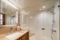 Luxurious bathroom in 2020 Ocean Alexander 100 MY yacht with glass shower and modern fixtures.