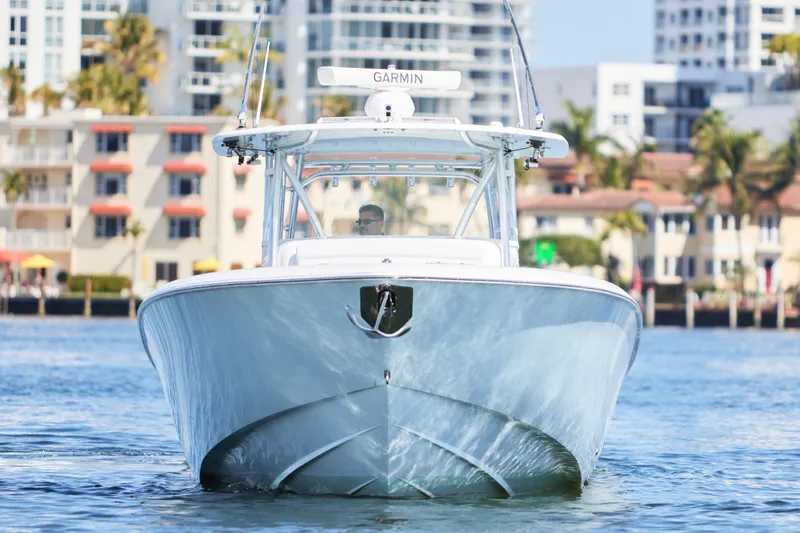  Yacht Photos Pics 2022 Contender 44 Fisharound boat cruising near urban waterfront buildings.