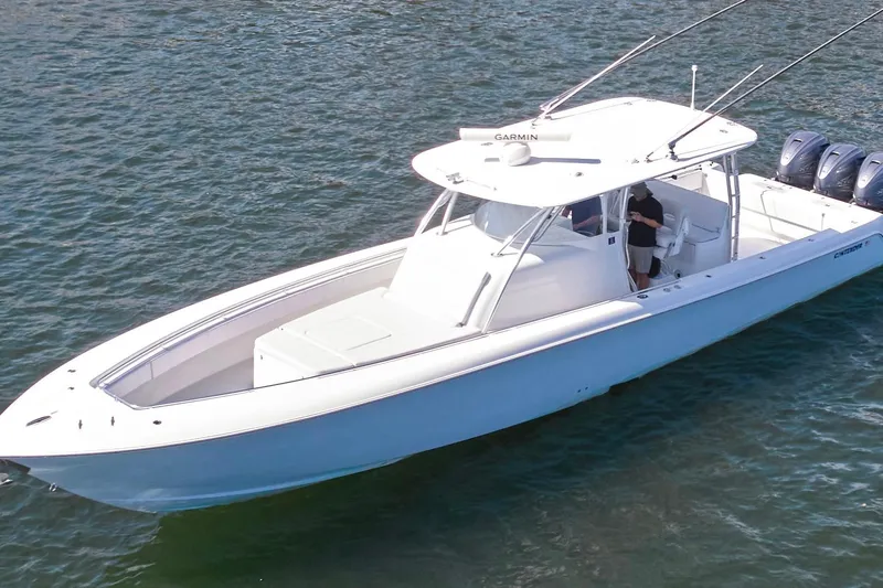  Yacht Photos Pics 2022 Contender 44 Fisharound boat on water, featuring sleek design and triple engines.