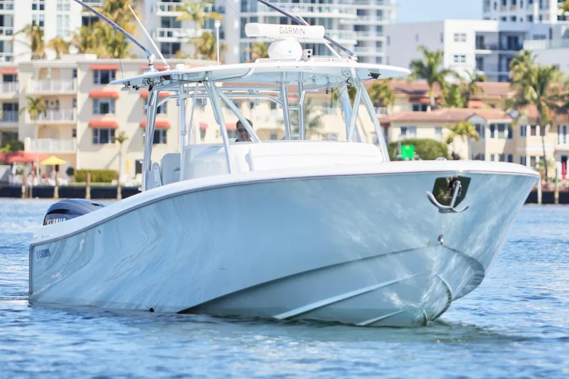  Yacht Photos Pics 2022 Contender 44 Fisharound boat cruising near waterfront buildings.